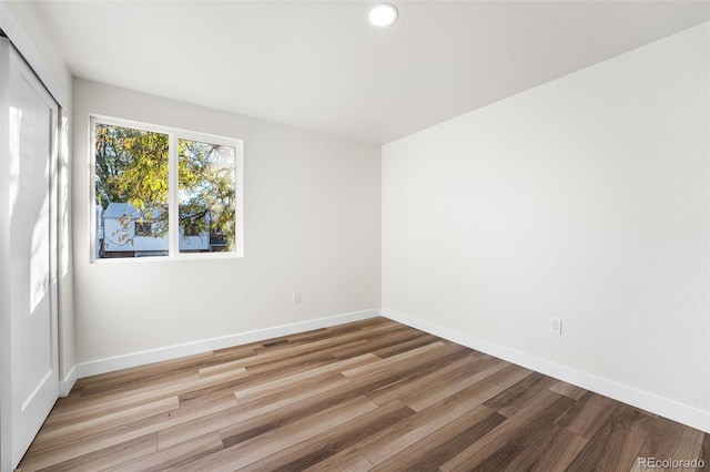 unfurnished room featuring hardwood / wood-style floors