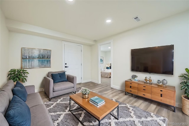 living room with light hardwood / wood-style flooring