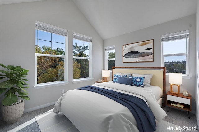 carpeted bedroom with lofted ceiling