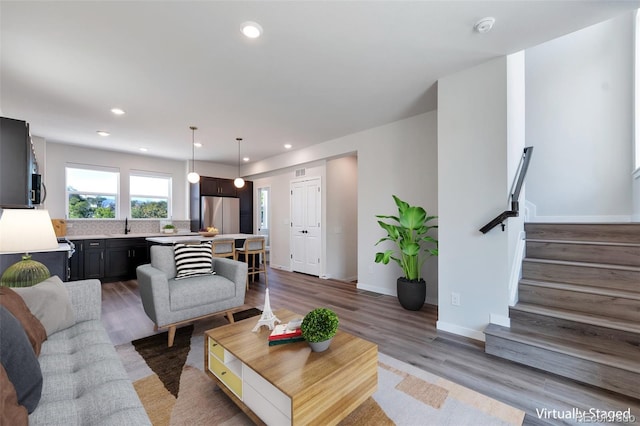 living room with hardwood / wood-style flooring and sink