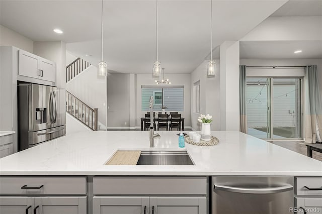 kitchen with stainless steel fridge with ice dispenser, light countertops, recessed lighting, gray cabinets, and hanging light fixtures