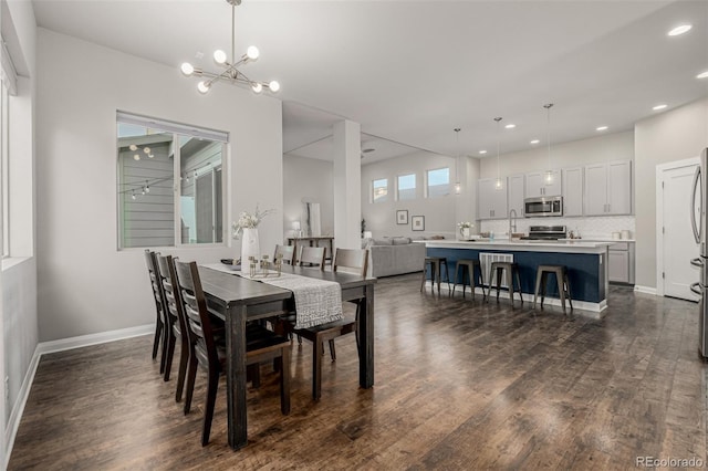 dining space with a notable chandelier, recessed lighting, dark wood-type flooring, and baseboards