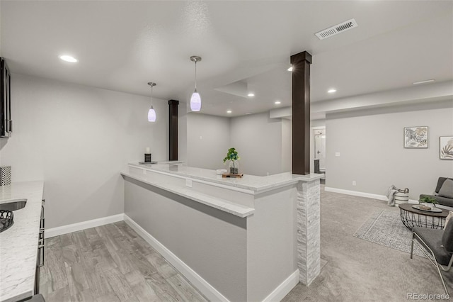 kitchen with decorative light fixtures, recessed lighting, baseboards, and visible vents