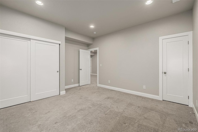 unfurnished bedroom featuring recessed lighting, a closet, baseboards, and carpet