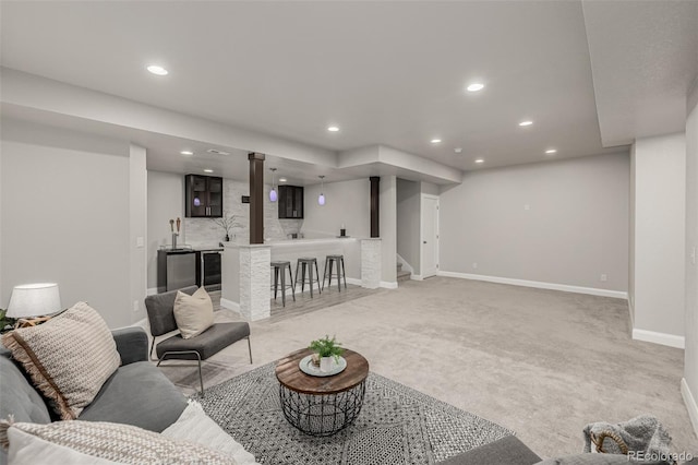 living area with bar area, baseboards, light colored carpet, stairs, and recessed lighting