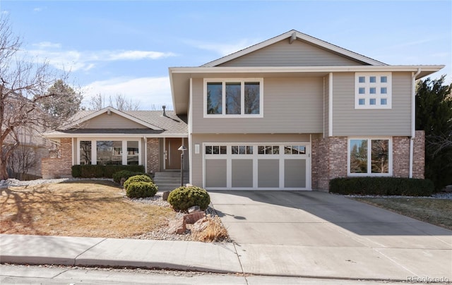 view of front of house with a garage, concrete driveway, and brick siding