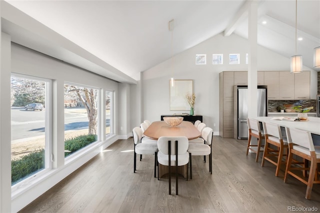 dining area with baseboards, beamed ceiling, light wood-type flooring, high vaulted ceiling, and recessed lighting