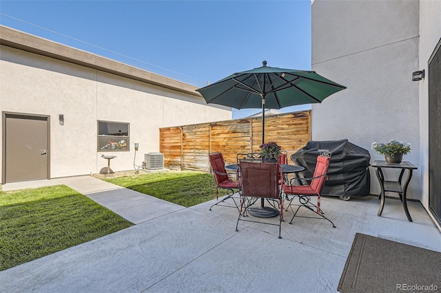 view of patio / terrace featuring outdoor dining area, fence, grilling area, and central AC unit