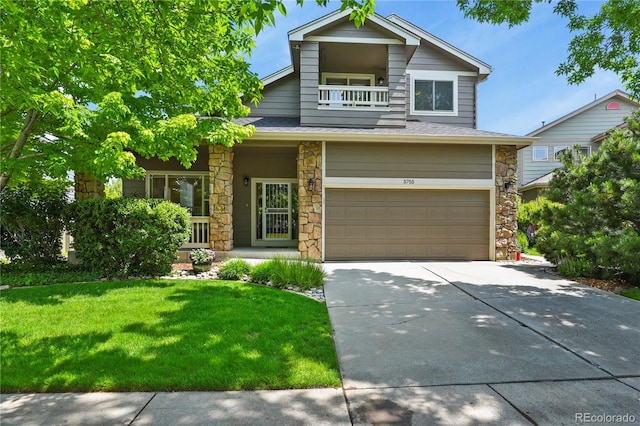 5755 W Berry Ave, Denver, CO 80123 - view of front facade featuring stone siding, a garage, driveway, a porch, and a front yard