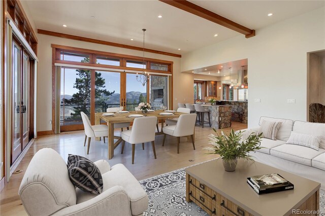 180 Outpost Ln, Evergreen, CO 80439 - living room featuring recessed lighting, beamed ceiling, a chandelier, and light wood-style flooring