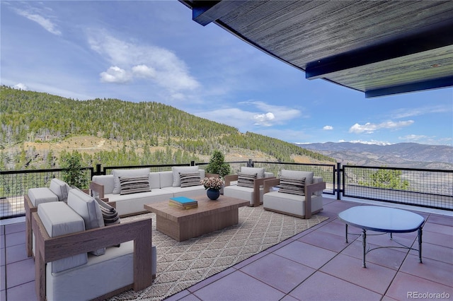 180 Outpost Ln, Evergreen, CO 80439 - view of patio / terrace with a mountain view, an outdoor living space, and a wooded view