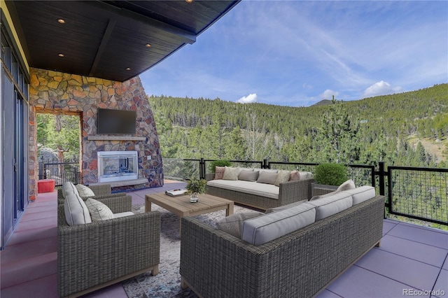 180 Outpost Ln, Evergreen, CO 80439 - view of patio with an outdoor living space with a fireplace