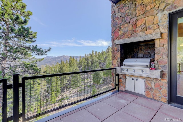 180 Outpost Ln, Evergreen, CO 80439 - balcony with grilling area, a mountain view, and exterior kitchen