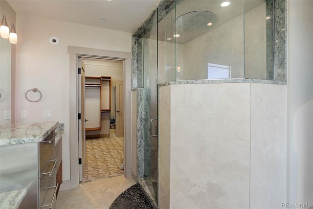 180 Outpost Ln, Evergreen, CO 80439 - full bathroom with a shower stall, a walk in closet, tile patterned floors, vanity, and recessed lighting