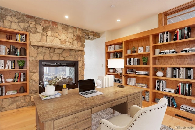 180 Outpost Ln, Evergreen, CO 80439 - office area featuring light wood-type flooring and a stone fireplace