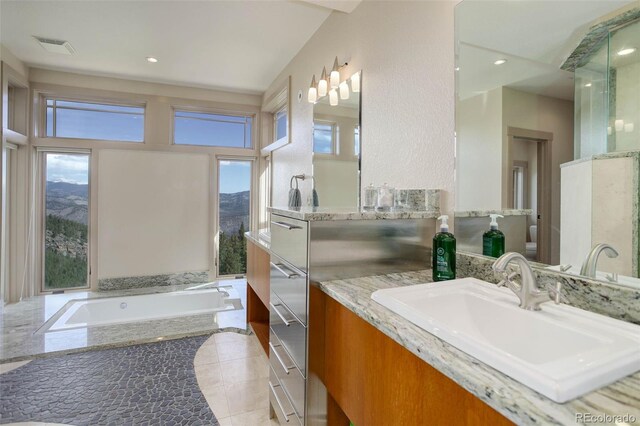 180 Outpost Ln, Evergreen, CO 80439 - bathroom with vanity, a bath, tile patterned floors, recessed lighting, and toilet