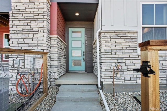 doorway to property featuring stone siding