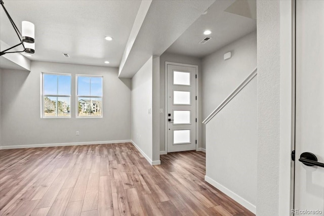 entrance foyer featuring recessed lighting, baseboards, and wood finished floors