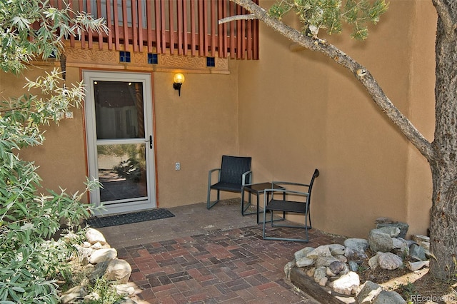 10 Baca Meadows Townhome Rd, Crestone, CO 81131 - view of exterior entry featuring a patio area and stucco siding