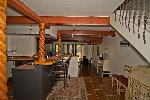 10 Baca Meadows Townhome Rd, Crestone, CO 81131 - indoor wet bar with tile patterned flooring, beamed ceiling, and rail lighting