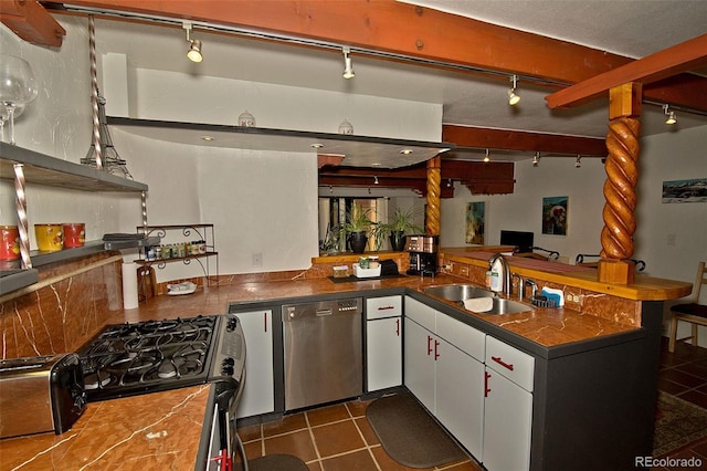 10 Baca Meadows Townhome Rd, Crestone, CO 81131 - kitchen featuring dishwasher, white cabinetry, dark countertops, gas range oven, and track lighting