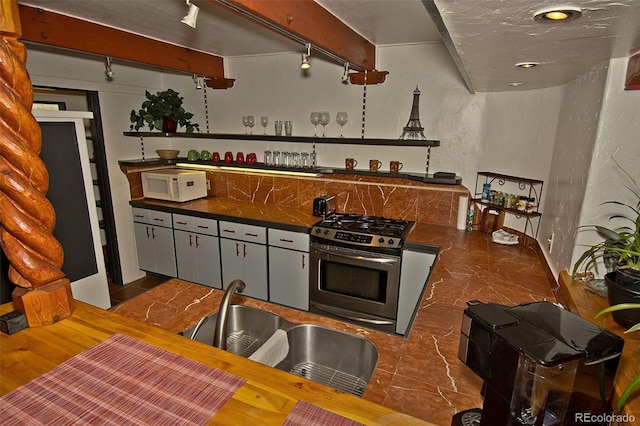 10 Baca Meadows Townhome Rd, Crestone, CO 81131 - kitchen featuring gas stove, white microwave, and dark countertops