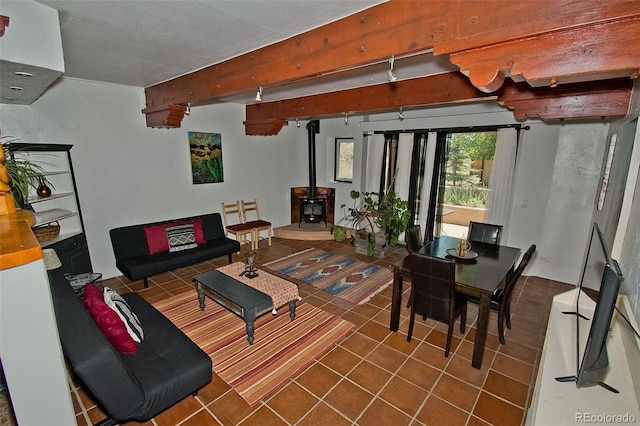 10 Baca Meadows Townhome Rd, Crestone, CO 81131 - tiled living area featuring a wood stove and beam ceiling