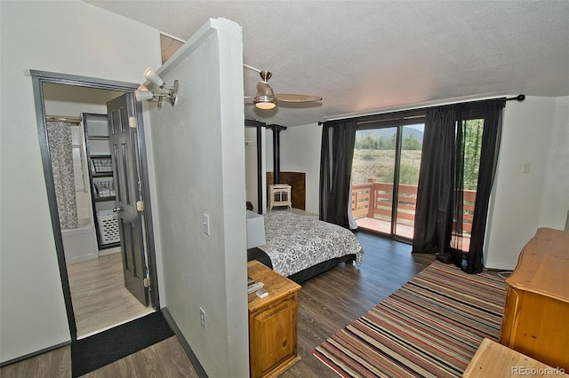 10 Baca Meadows Townhome Rd, Crestone, CO 81131 - bedroom with access to exterior, wood finished floors, a wood stove, a textured ceiling, and a ceiling fan