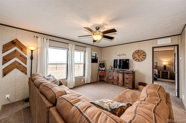 living room with light carpet, ceiling fan, and ornamental molding