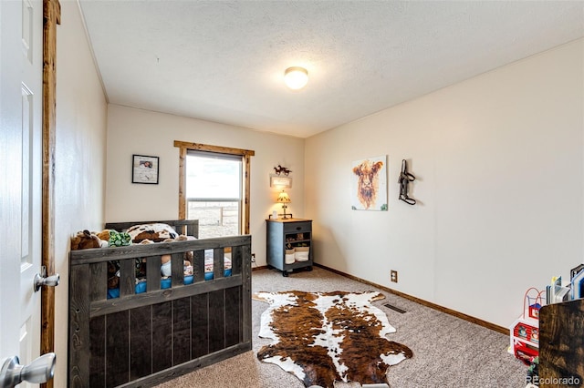 carpeted bedroom featuring baseboards