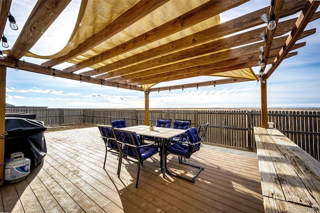 wooden terrace with outdoor dining space and fence