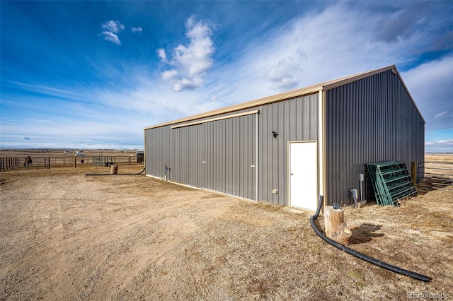 view of pole building featuring fence