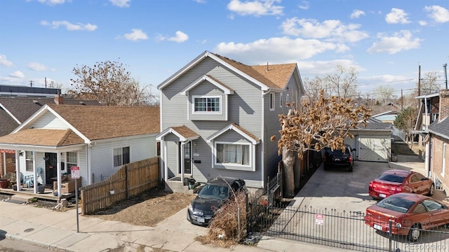 view of front facade with a fenced front yard and a shingled roof