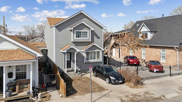 view of front of house featuring entry steps and fence