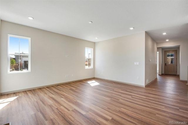 24593 E 34th Ave, Aurora, CO 80019 - unfurnished room with wood finished floors, baseboards, and recessed lighting