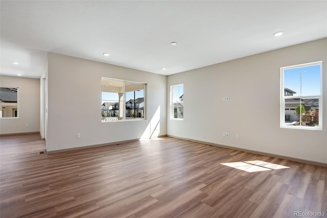 24593 E 34th Ave, Aurora, CO 80019 - unfurnished living room with wood finished floors, baseboards, and recessed lighting