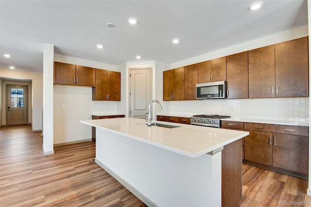 24593 E 34th Ave, Aurora, CO 80019 - kitchen with stainless steel appliances, a sink, light wood-style flooring, decorative backsplash, and recessed lighting