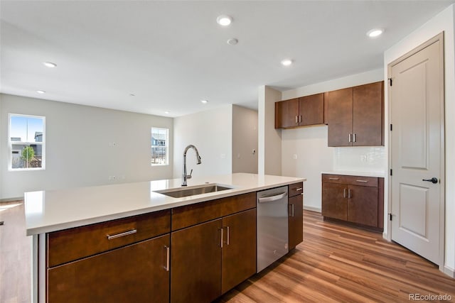 24593 E 34th Ave, Aurora, CO 80019 - kitchen with stainless steel dishwasher, a sink, wood finished floors, light countertops, and healthy amount of natural light