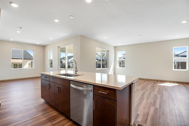 24593 E 34th Ave, Aurora, CO 80019 - kitchen with dishwasher, a sink, light wood-style flooring, open floor plan, and light countertops