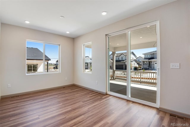 24593 E 34th Ave, Aurora, CO 80019 - spare room featuring wood finished floors, baseboards, and recessed lighting