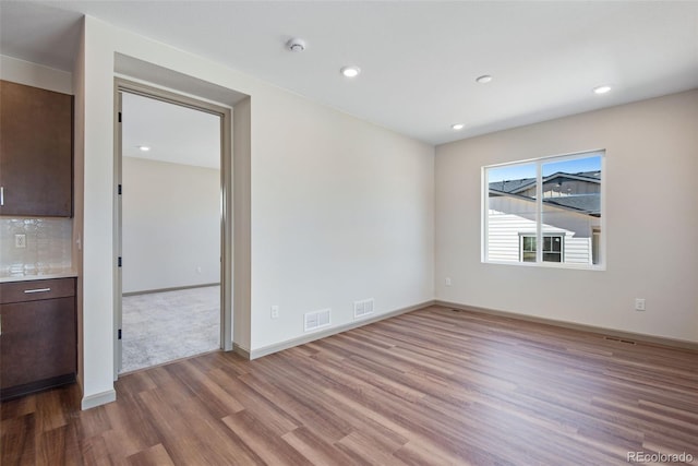 24593 E 34th Ave, Aurora, CO 80019 - unfurnished room featuring wood finished floors, baseboards, recessed lighting, and a smoke detector