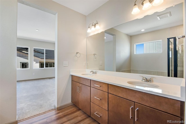 24593 E 34th Ave, Aurora, CO 80019 - bathroom featuring wood finished floors, double vanity, and baseboards