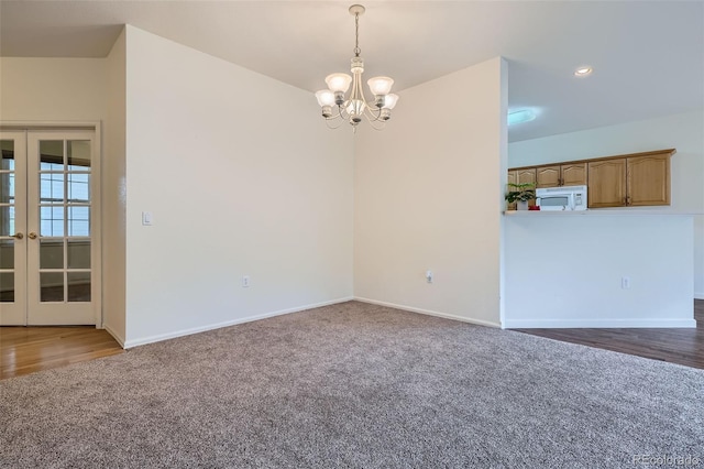 7831 S Addison Way, Aurora, CO 80016 - carpeted spare room featuring a chandelier and french doors