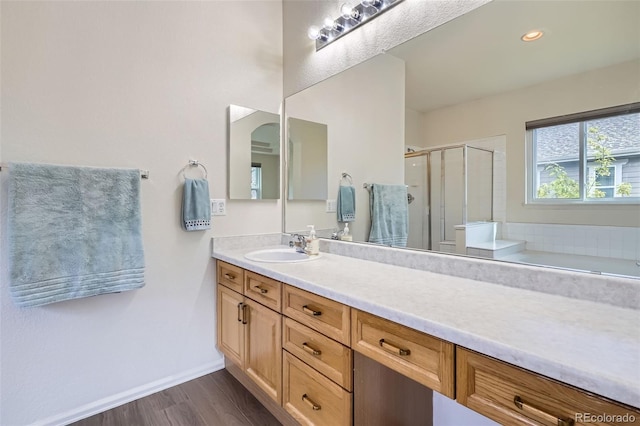 7831 S Addison Way, Aurora, CO 80016 - bathroom with vanity, a shower stall, wood finished floors, and a bath
