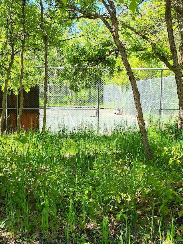 view of tennis court with fence