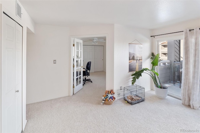 interior space with light carpet and french doors