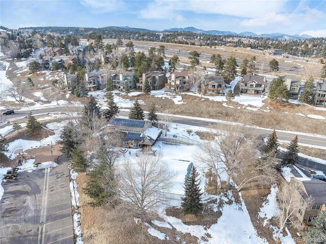 snowy aerial view with a mountain view