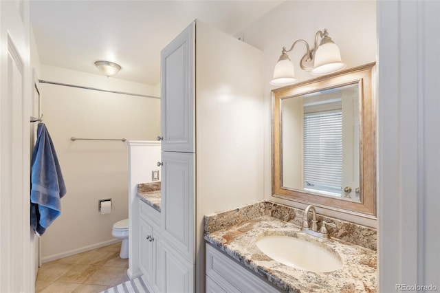 full bathroom with toilet, tile patterned flooring, vanity, and baseboards