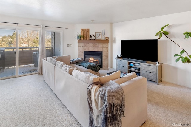 living room with a tiled fireplace and light colored carpet