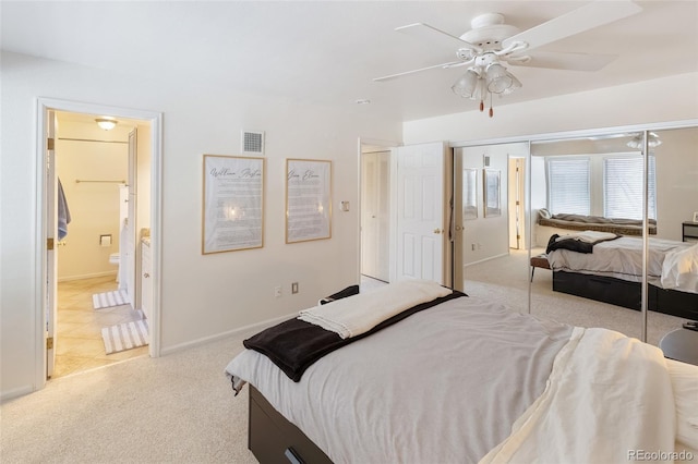 bedroom featuring visible vents, ensuite bathroom, carpet flooring, ceiling fan, and baseboards